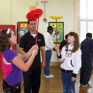 Larry teaching children to spin plates