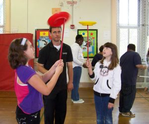 Larry teaching children to spin plates